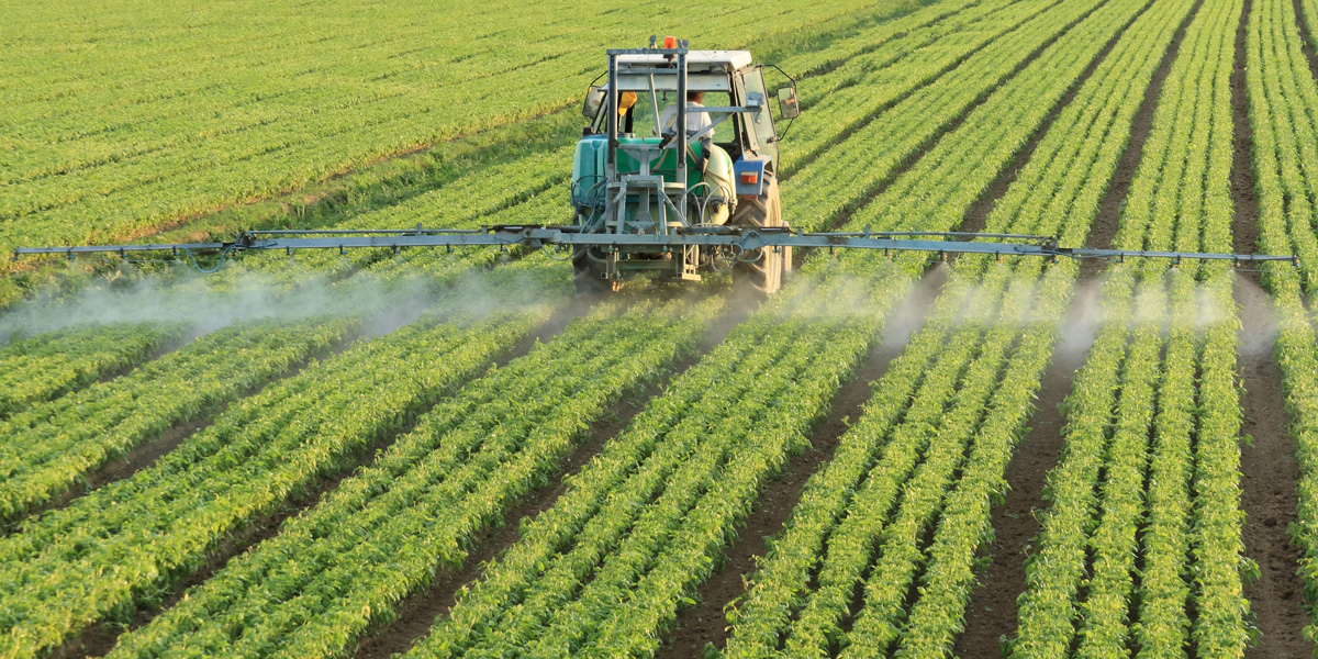 Farming tractor spraying glyphosate