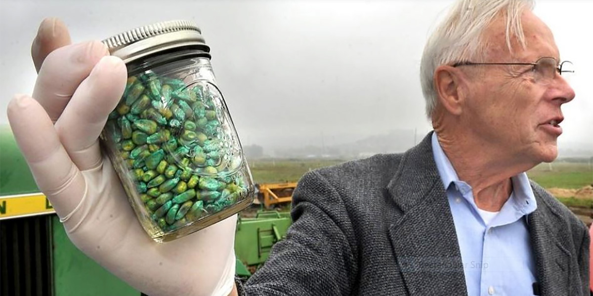 Ramon Seidler holding a jar of GM Maize