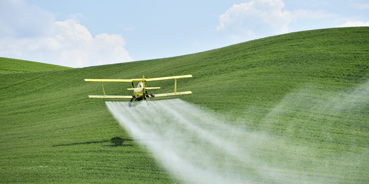Biplane Crop Duster Spraying Glyphosate pesticide