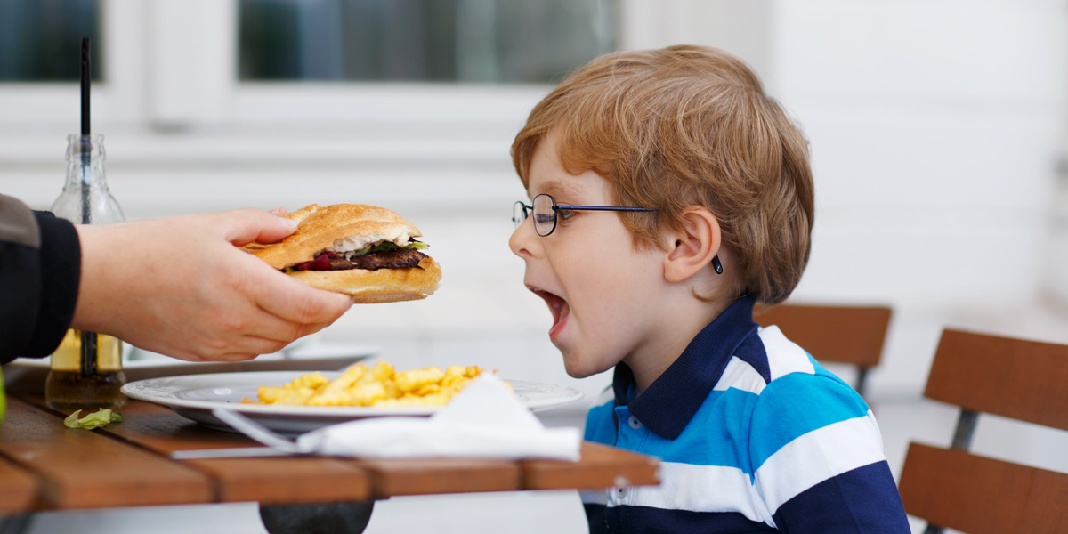 Little Boy Eating Fast Food