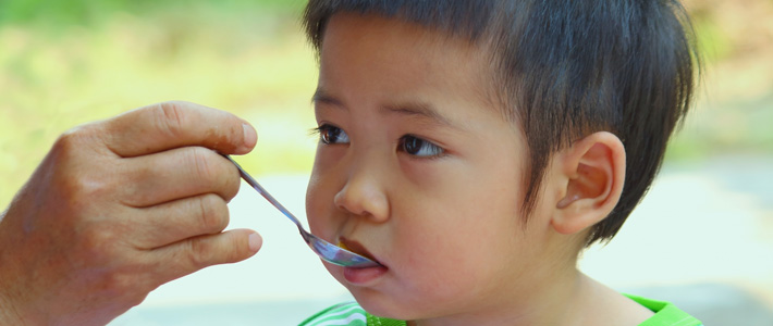 child eating rice